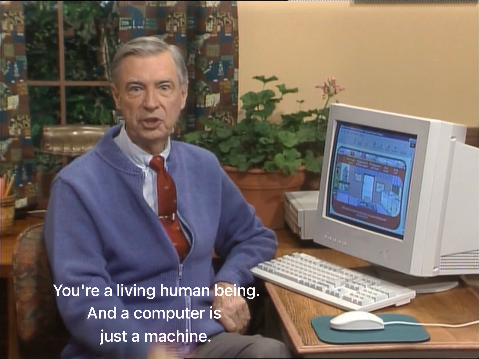 Esta imagem mostra Fred Rogers, apresentador do programa infantil &ldquo;Mister Rogers&rsquo; Neighborhood&rdquo;, conversando com o espectador sobre o papel da tecnologia. A frase destaca a importância da humanidade em relação às máquinas.